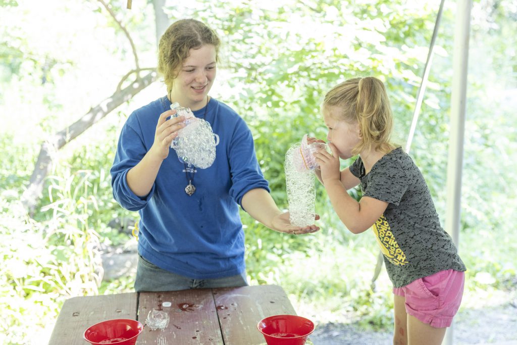 photo of child blowing bubbles