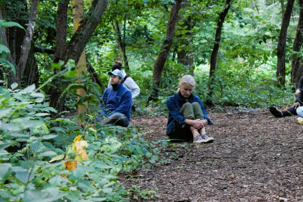 photo of participants meditating in the woods