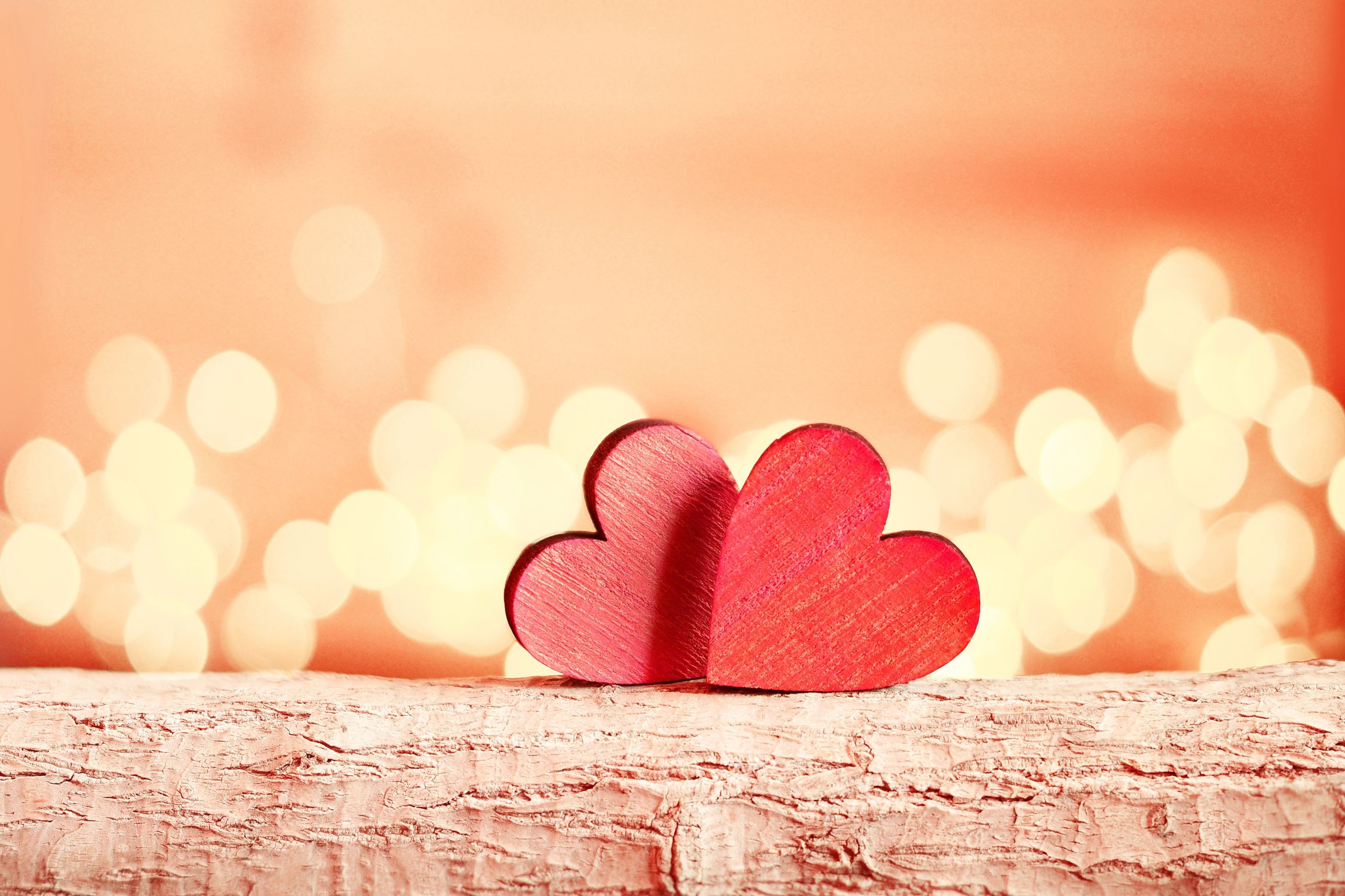 photo of two hearts on a log