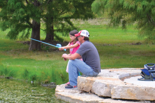 photo of particpants fishing at the fishing derby